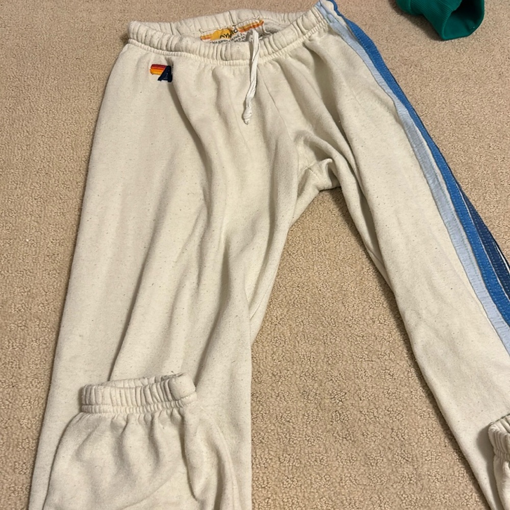 Aviator Nation cream sweatpants with 5 stipe blue ombré on the side